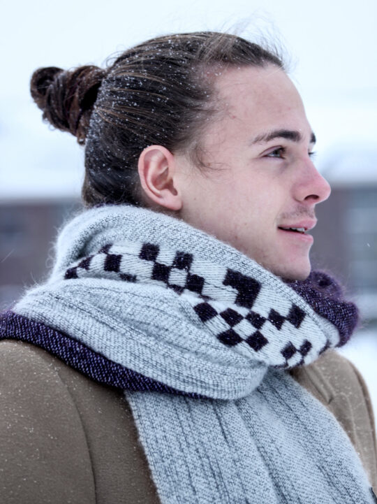 Guy wearing a soft mohair scarf in the winter.